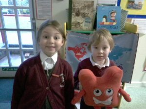 Infant pupils receiving jigsaw award